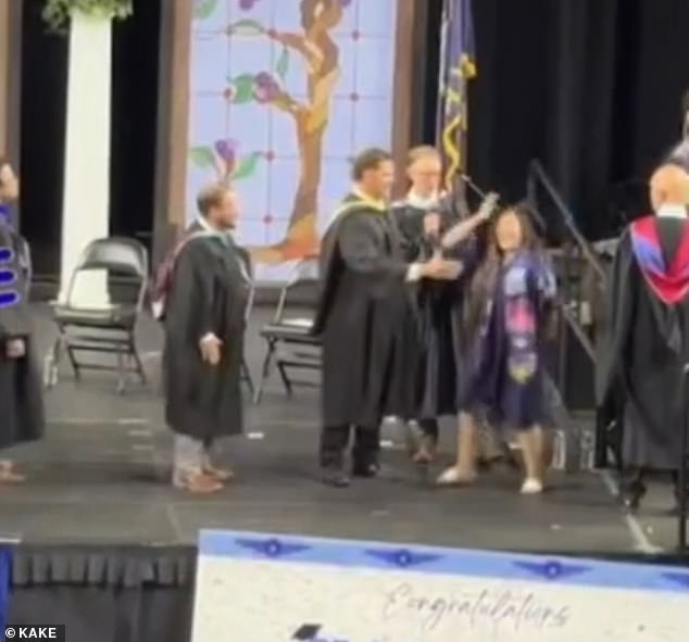 Kansas graduates forced into awkward handshakes by aggressive administrators